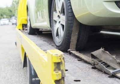 car transporter breakdown lorry during working using locked belt transport other green car for repairing at car center in a bangkok city thailand